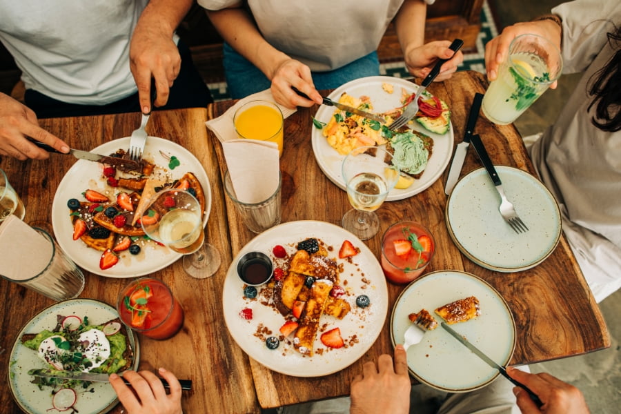 group of four people eating brunch at a restaurant