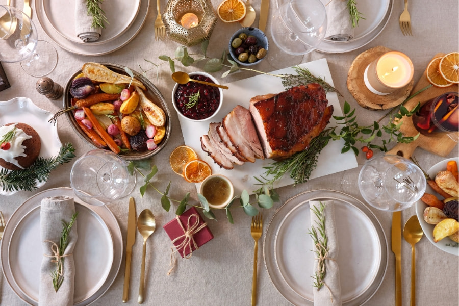 dining table full of Thanksgiving turkey and side dishes 