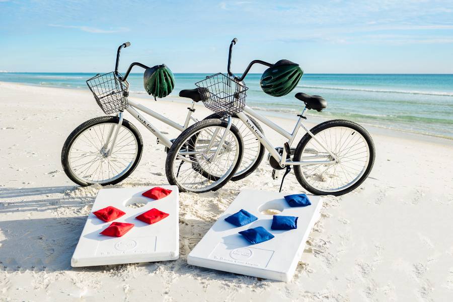 Bicycles and corn hole boards on a beach